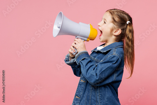 Little child kid girl 7-8 years old she wears denim shirt hold in hand megaphone scream announces discounts sale Hurry up isolated on plain pink background. Mother's Day love family lifestyle concept.