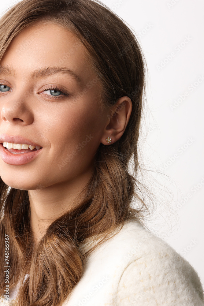 Beautiful young girl with fresh healthy skin. Woman advertise ear-rings. White background. Earrings closeup. Blond european woman with long hair with big lips, pretty smile. Cosmetology, scincare Beautiful young girl with fresh healthy skin. Woman advertise ear-rings. White background. Earrings closeup. Blond european woman with long hair with big lips, pretty smile. Cosmetology, scincare