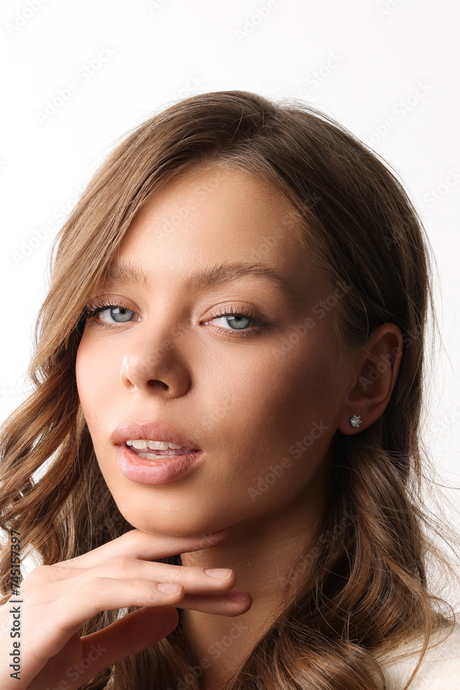Beautiful young girl with fresh healthy skin. Woman advertise ear-rings. White background. Earrings closeup. Blond european woman with long hair with big lips, pretty smile. Cosmetology, scincare Beautiful young girl with fresh healthy skin. Woman advertise ear-rings. White background. Earrings closeup. Blond european woman with long hair with big lips, pretty smile. Cosmetology, scincare