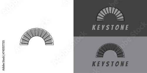 Modern typography keystone logo in grey color presented with multiple white and grey background colors. The logo is suitable for brand and fashion business logo design inspiration templates. photo