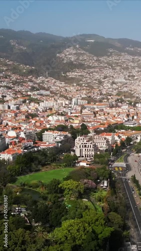 Vertical video 9:16 for social media story Aerial view of town with buildings with red roofs Funchal Madeira drone