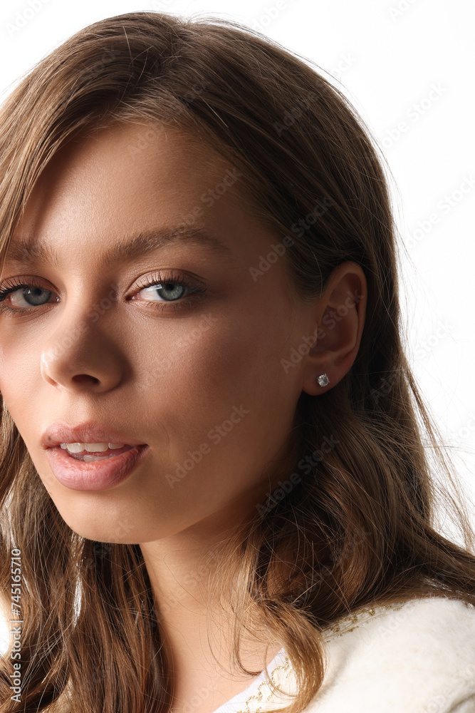 Beautiful young girl with fresh healthy skin. Woman advertise ear-rings. White background. Earrings closeup. Blond european woman with long hair with big lips, pretty smile. Cosmetology, scincare Beautiful young girl with fresh healthy skin. Woman advertise ear-rings. White background. Earrings closeup. Blond european woman with long hair with big lips, pretty smile. Cosmetology, scincare