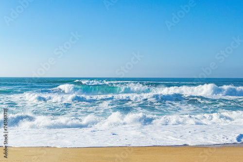 Fototapeta Naklejka Na Ścianę i Meble -  Beautiful ocean waves on a golden sand beach. Alone with nature.