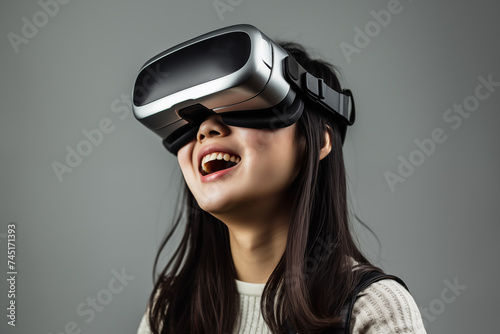  portrait of a smiling girl of Asian appearance wearing virtual reality glasses © Evgeniya