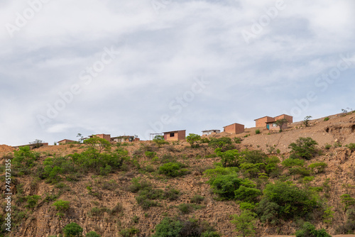houses built on a hill, hillside settlements, urban development in latin america © M Grayson