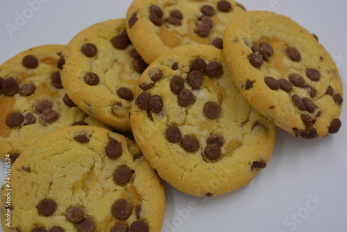 Sweets, delicious, large cookies with small pieces of milk chocolate arranged on a white background.