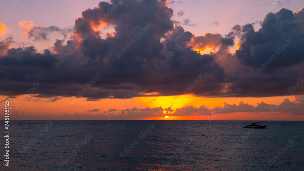Beautiful orange sunset over the sea clouds.