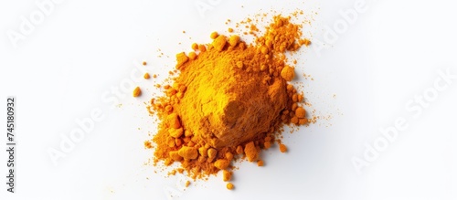 A top-down view of a mound of bright yellow Turmeric Curcuma powder neatly arranged on a clean white surface.