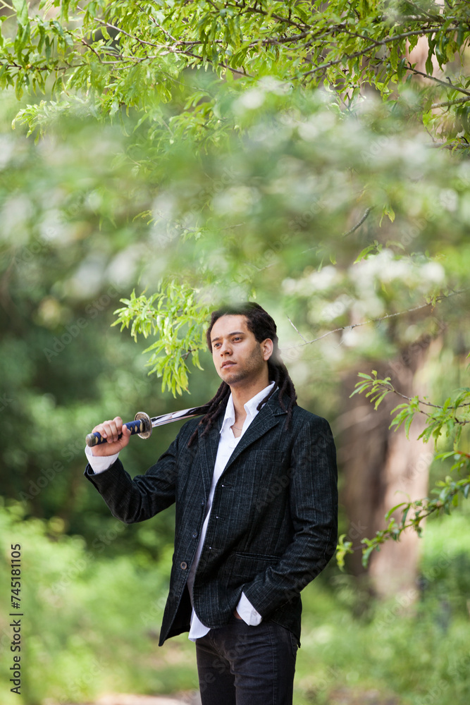 Brazilian individual with rastas, holding a samurai sword Brazilian individual with rastas, holding a samurai sword