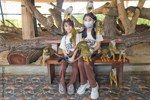 Photography Family enjoying squirrel monkey in the park