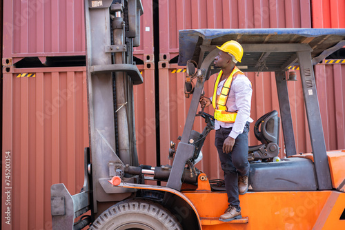 Engineer loads goods by forklift to stack containers