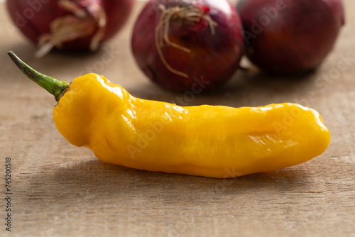 Whole fresh raw ripe yellow Madame Jeanette pepper close up on wood © Picture Partners