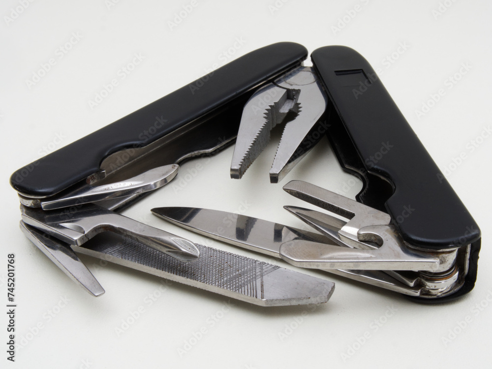 Closeup of a traditional multi-tool pocket knife – often used for camping and hiking - opened out and isolated. Closeup of a traditional multi-tool pocket knife – often used for camping and hiking - opened out and isolated.