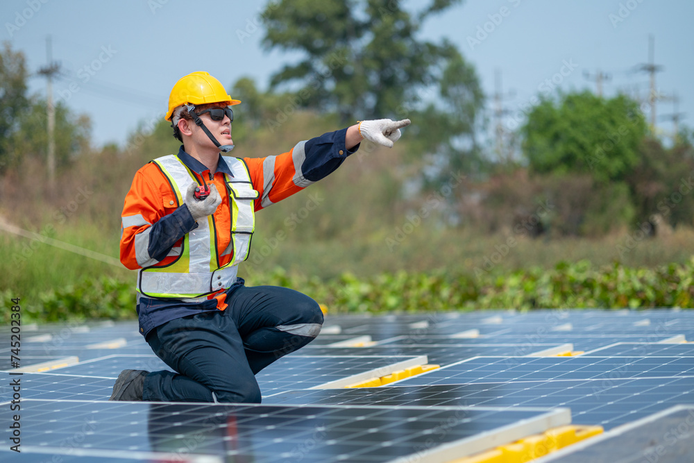 Solar Field Technician Examining Panel Efficiency Solar Field Technician Examining Panel Efficiency