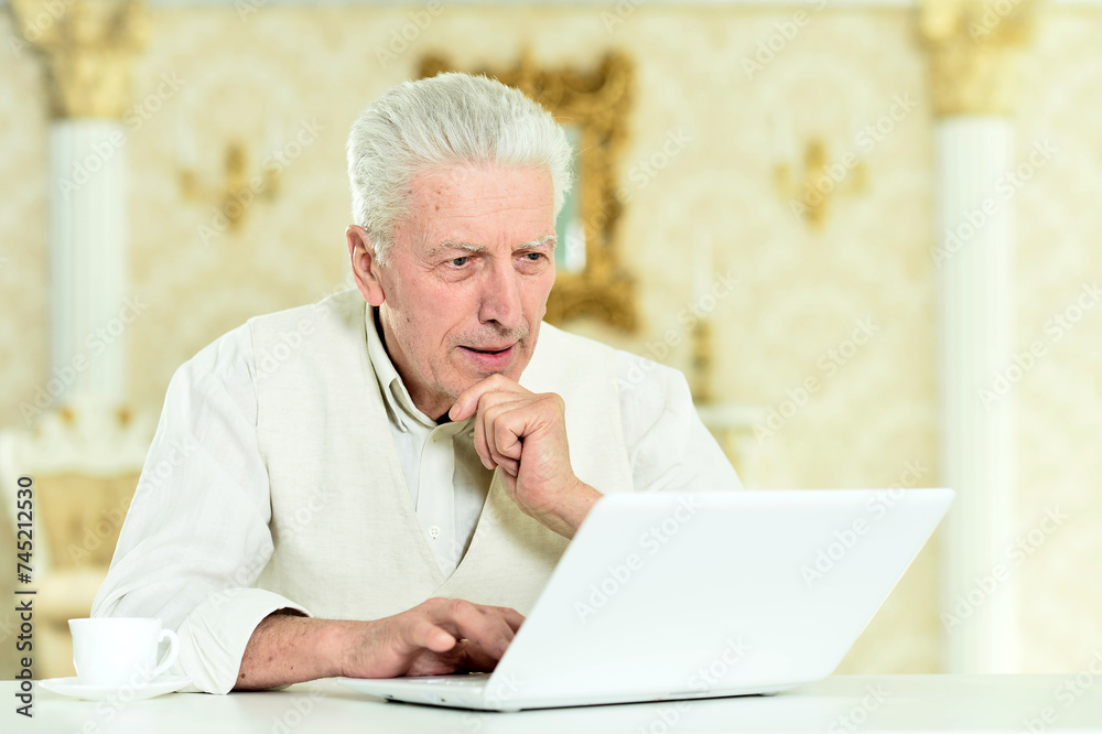 Portrait of thoughtful senior man with laptop Portrait of thoughtful senior man with laptop