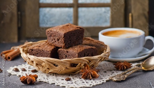 Brownies in a basket. Cup of coffee in the composition.
