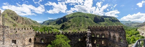 Panorama of Mtkvari (Kura) and Paravani river valley and green Lesser Caucasus mountains with Khertvisi Fortress stone defense crenellated wall, Samtskhe - Javakheti region, Georgia.