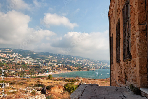 View of the Mediterranean sea coast in Byblos. With view on the ancient ruins and modern town. photo