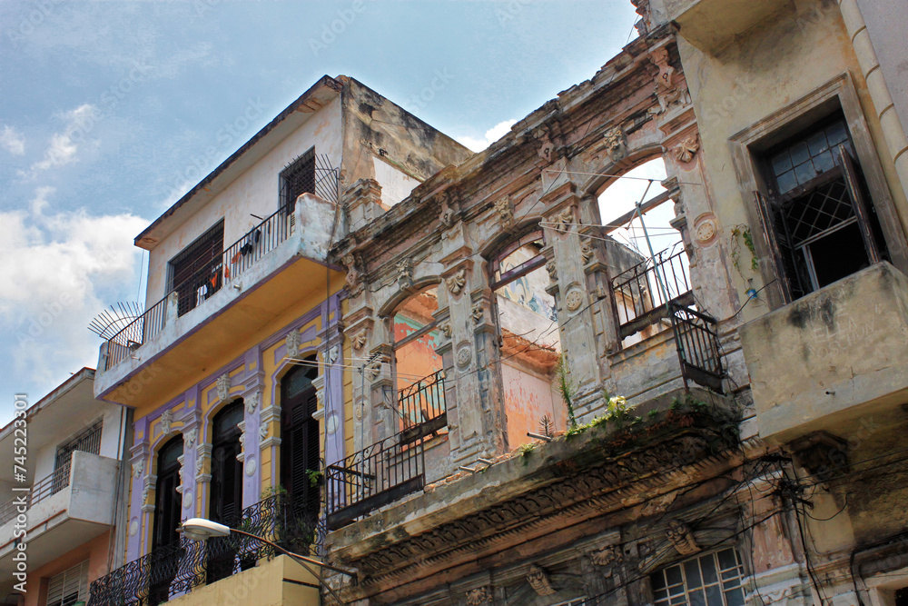 View of one of the ruined buildings built in colonial style on one of the central streets in the historic part of Havana. Cuba. View of one of the ruined buildings built in colonial style on one of the central streets in the historic part of Havana. Cuba.