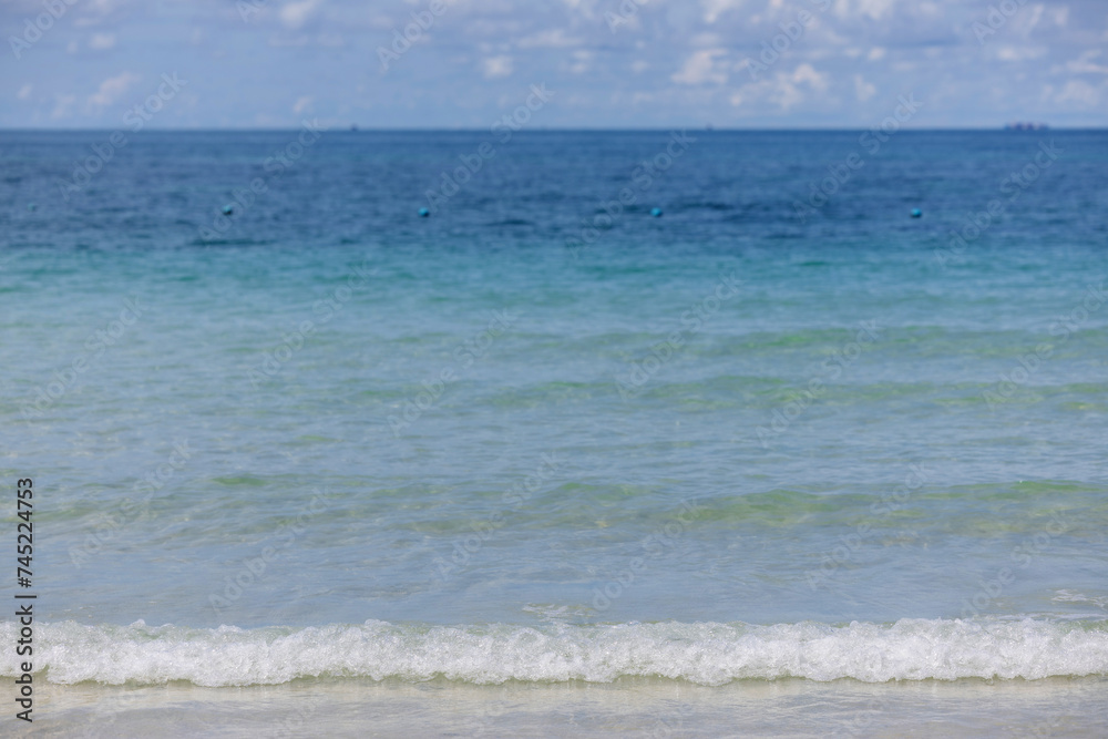 Soft wave of ocean on sandy beach. Wave of the sea on the sand beach. White sand beach and blue sky. Soft wave of ocean on sandy beach. Wave of the sea on the sand beach. White sand beach and blue sky.