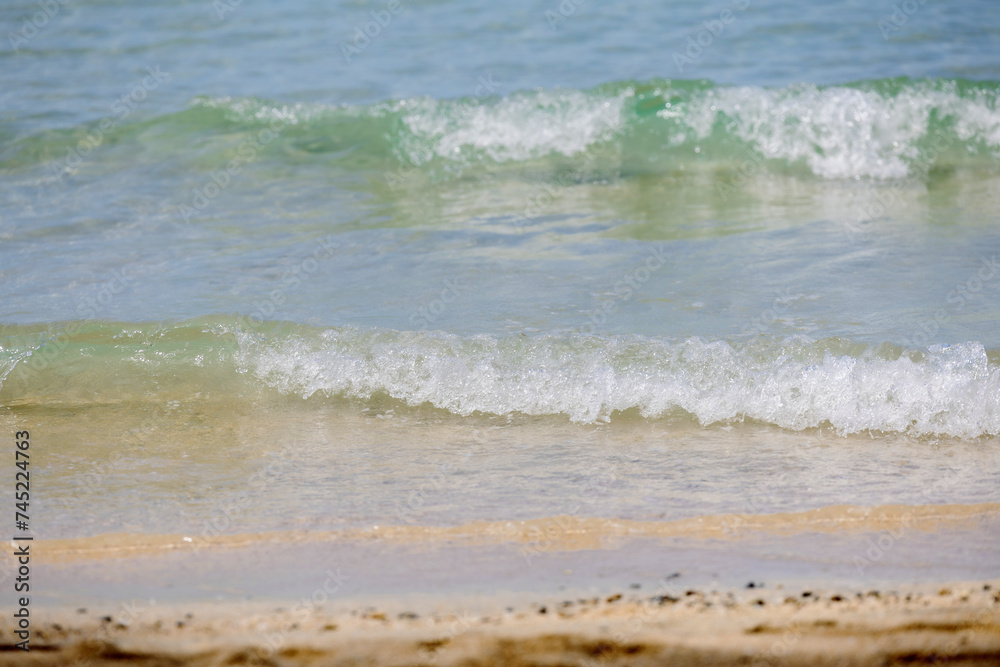 Soft wave of ocean on sandy beach. Wave of the sea on the sand beach. White sand beach and blue sky. Soft wave of ocean on sandy beach. Wave of the sea on the sand beach. White sand beach and blue sky.