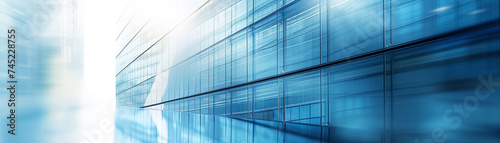 Close-up of a modern office building glass facade, reflecting the sky with a blue gradient effect. Perfect for simple poster layout.
