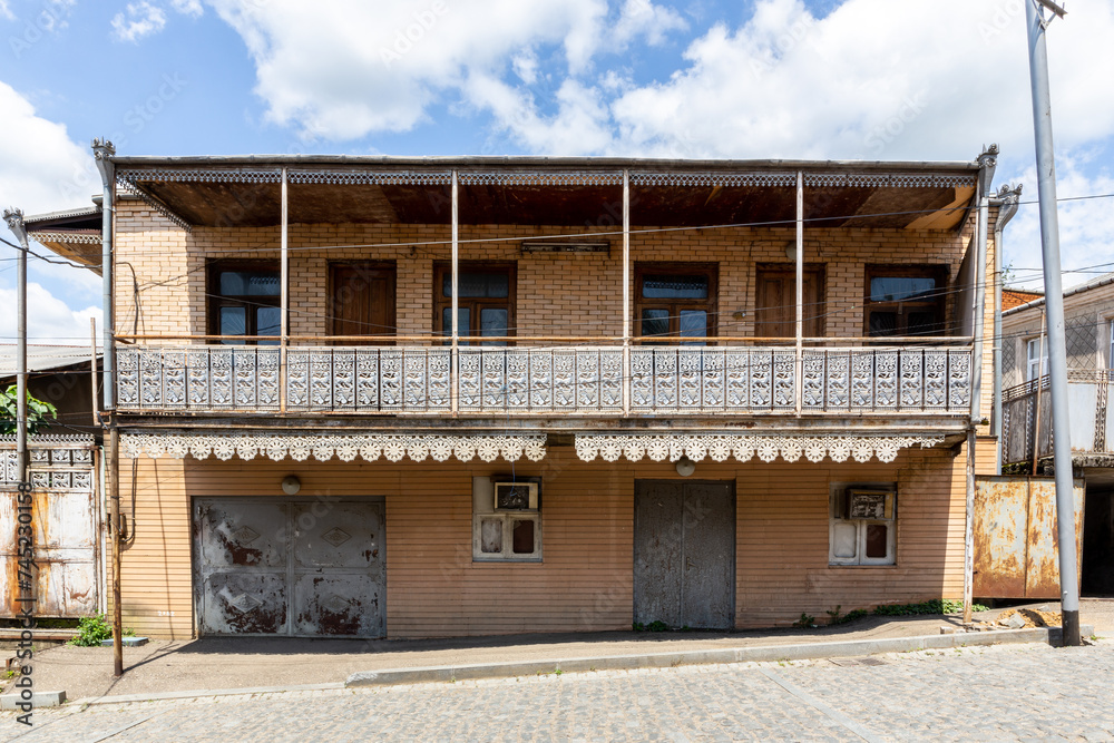 Traditional residential two-storey house in Kutaisi with lathed openwork ornamental balcony. Traditional residential two-storey house in Kutaisi with lathed openwork ornamental balcony.