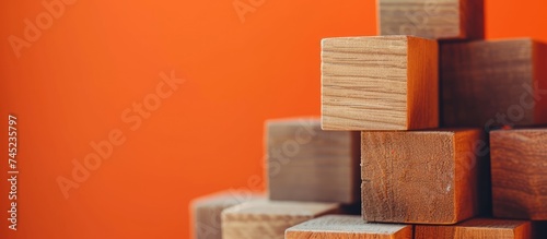 A stack of wooden blocks against a vibrant orange wall  showcasing the concept of service provider in a business setting. The wooden blocks feature text related to different business services