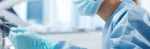 Professional female dentist in protective mask and gloves using dental tools while working in modern clinic photo