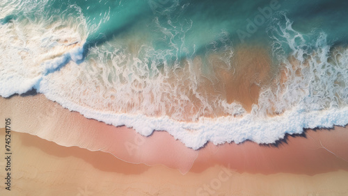Aerial view of a pristine beach with foamy waves gently caressing the sandy shore.