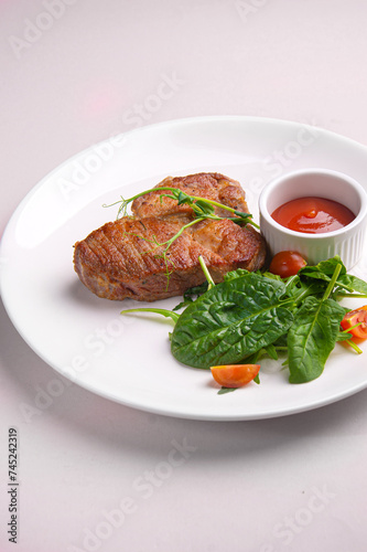 Meat steak with tomato sauce and herbs