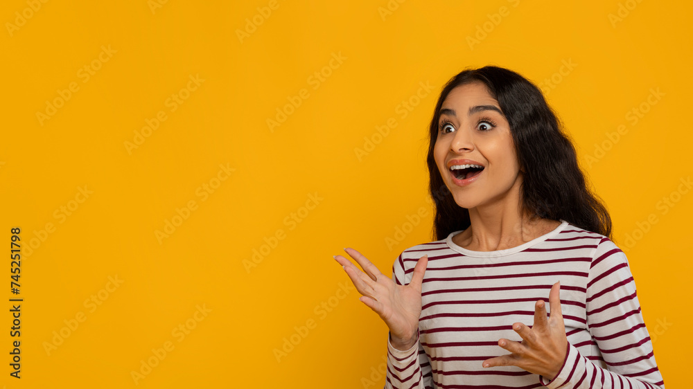 Amazed hindu lady looking at copy space and gesturing Amazed hindu lady looking at copy space and gesturing