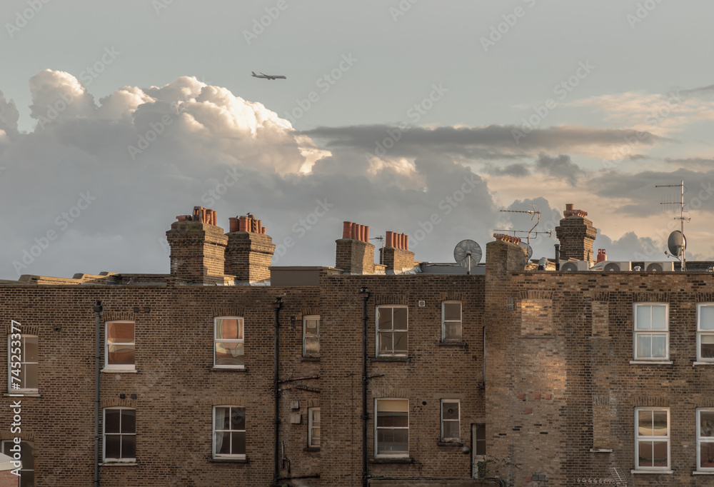 Rear view of urban brick apartment buildings and old houses in london with sky background at evening. Exterior of The Windows and decoration of walls, Space for text, Selective focus.
