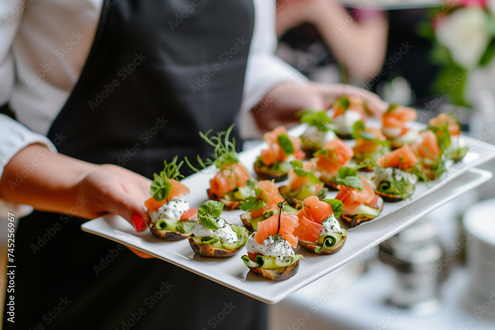 Fototapeta premium Elegant party appetizers: seafood and cheese canapes on a waiter's tray.