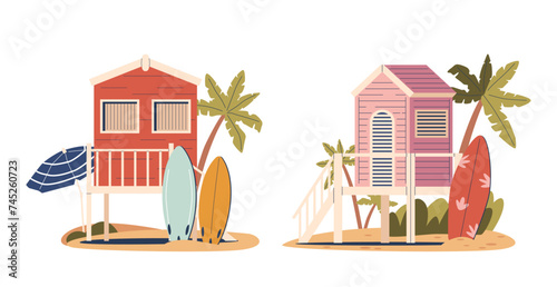 Beach Houses On Piles Stand Elevated Above The Sand. Summer Huts With Surfing Boards, Offering Ocean Views