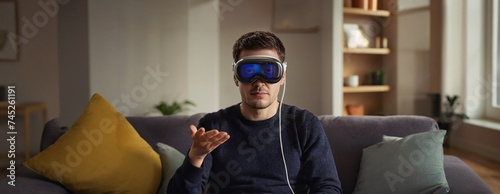 Man wearing a VR headset is interacting with virtual content in a cozy living room, depicting leisure tech use and entertainment, vision pro.