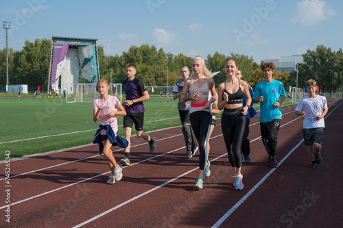 Group of young athlete runnner are training © olinchuk