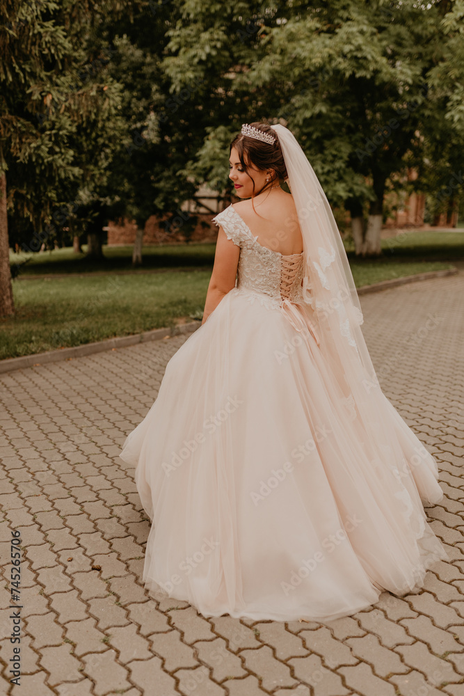 Obraz premium Caucasian young woman bride spinning whirls dancing posing moving at nature