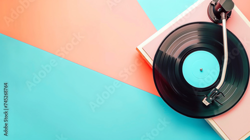 Record player with vinyl record banner on peach and blue background photo