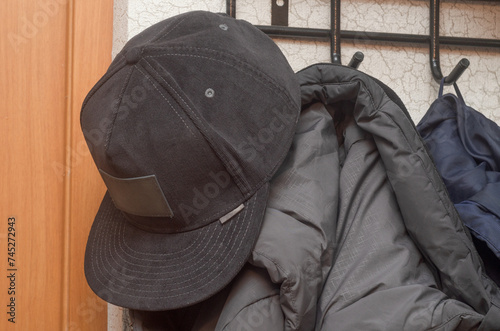 black cap on a hanger with a jacket