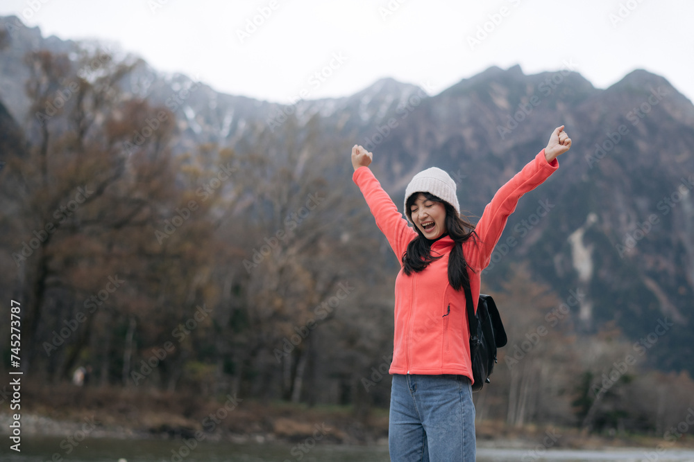 Asian woman in a pink fleece enjoys the freedom of a snowy adventure. Elegant portrait by the lake, capturing the excitement and exploration of a scenic journey. Asian woman in a pink fleece enjoys the freedom of a snowy adventure. Elegant portrait by the lake, capturing the excitement and exploration of a scenic journey.