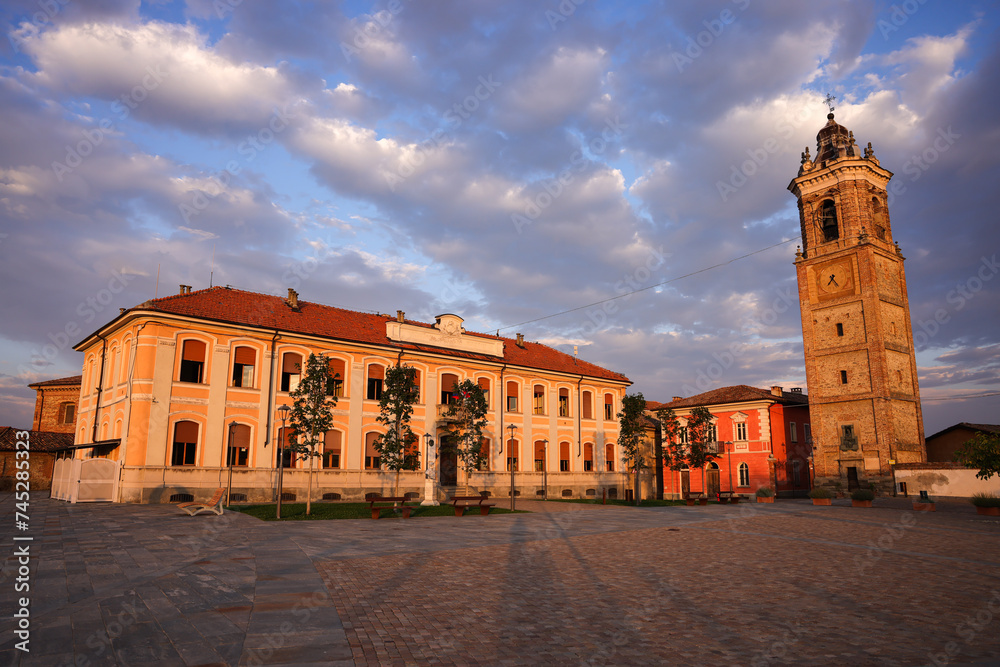 the church tower and school building of La Morra at sunrise - obrazy, fototapety, plakaty 