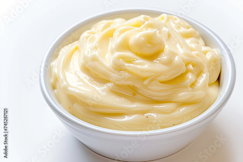 White Bowl Filled With Yellow Sauce on Table