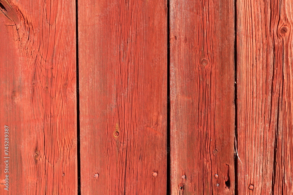 Red vertical wooden plank. Part of a wall. Red vertical wooden plank. Part of a wall.