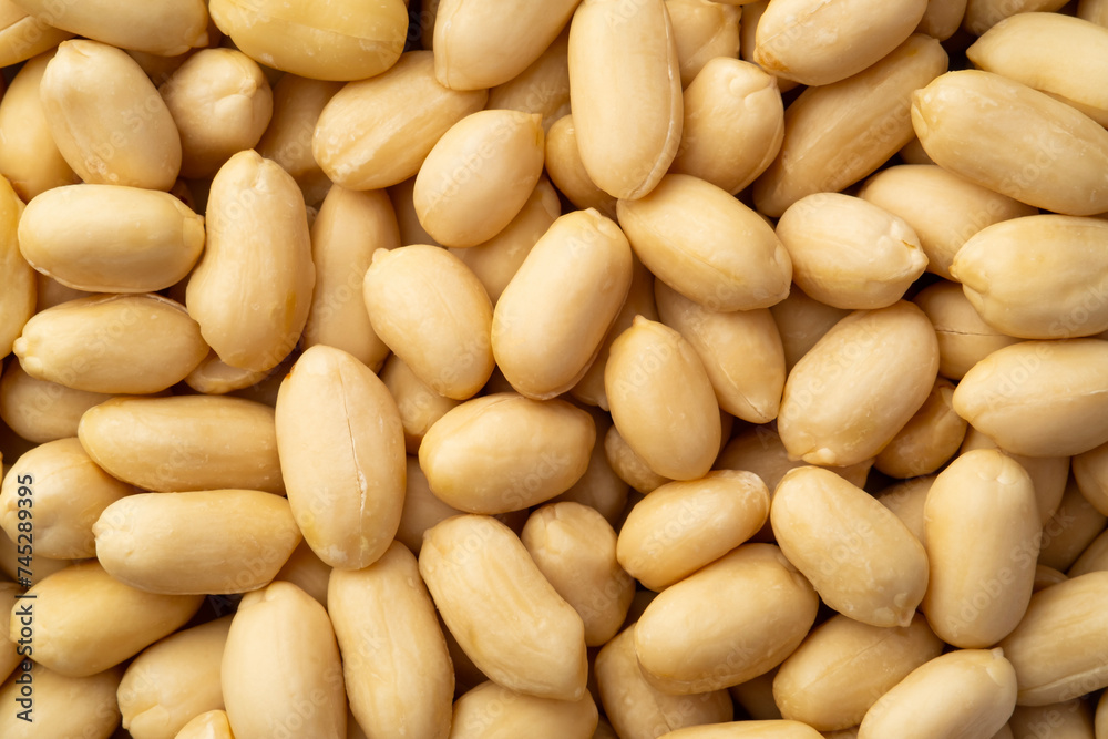 Close up Raw Uncooked peeled peanuts for background.Top view Close up Raw Uncooked peeled peanuts for background.Top view