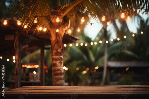 Nighttime garden decor. wood table with fairy lights hanging on tree, bokeh background