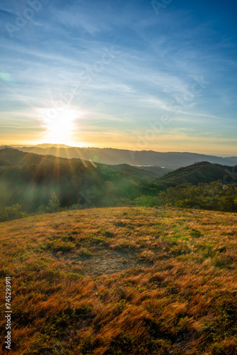 Ta Nang - Phan Dung route with milestone between 3 provinces through grass hills and forests in Song Mao Nature Reserve © CravenA