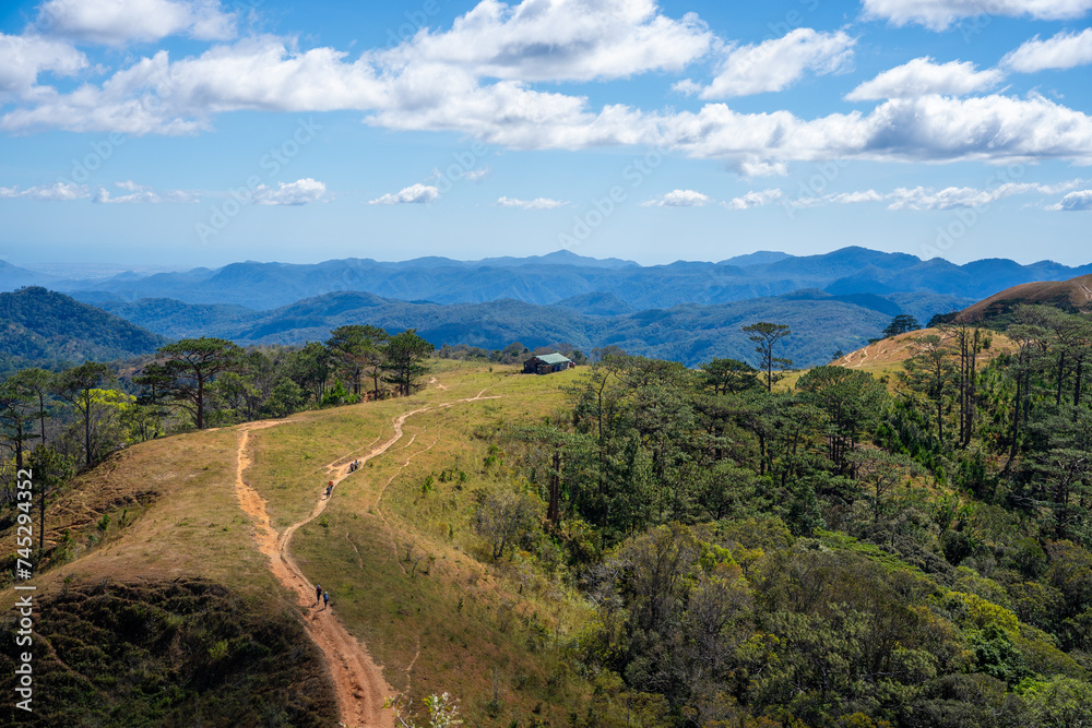 Ta Nang - Phan Dung route with milestone between 3 provinces through grass hills and forests in Song Mao Nature Reserve