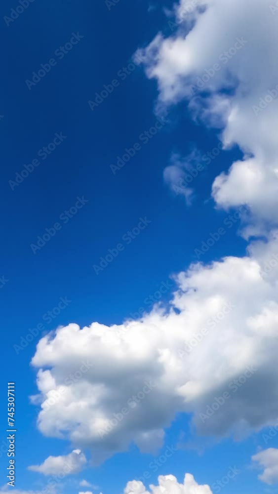 Amazing bright blue sky with little clouds flying through. Beautiful timelapse of fluffy clouds transformation. Vertical video. Amazing bright blue sky with little clouds flying through. Beautiful timelapse of fluffy clouds transformation. Vertical video.