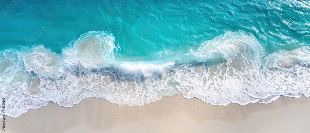 a bird's eye view of a beach with waves crashing on the sand and the ocean in the background.